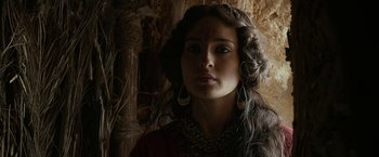 Movie still from “Exodus: Gods and Kings” (2014), directed by Ridley Scott – A woman with long curly hair wearing a necklace and earrings; Close Up shot, Over the shoulder angle