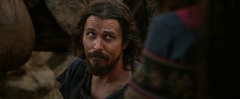 Movie still from “Exodus: Gods and Kings” (2014), directed by Ridley Scott – A person with long hair and a beard; Close Up shot, Over the shoulder angle