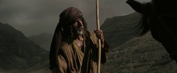 Movie still from “Exodus: Gods and Kings” (2014), directed by Ridley Scott – An old man holding a stick in his hand; Medium shot, Low angle