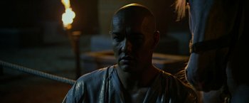 Movie still from “Exodus: Gods and Kings” (2014), directed by Ridley Scott – A man with a bald head is looking at the camera; Close Up shot, Over the shoulder angle