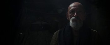 Movie still from “Exodus: Gods and Kings” (2014), directed by Ridley Scott – An old man with a white beard is looking at the camera; Close Up shot, Over the shoulder angle