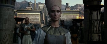 Movie still from “Exodus: Gods and Kings” (2014), directed by Ridley Scott – A woman wearing a gold headdress and a silver outfit; Close Up shot, Over the shoulder angle
