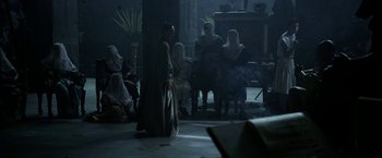 Movie still from “Exodus: Gods and Kings” (2014), directed by Ridley Scott – A group of people sitting in a dark room; Wide shot, High angle