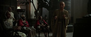 Movie still from “Exodus: Gods and Kings” (2014), directed by Ridley Scott – A group of people sitting in a room with statues; Medium shot, Over the shoulder angle