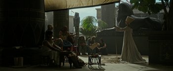 Movie still from “Exodus: Gods and Kings” (2014), directed by Ridley Scott – A group of people sitting around a table; Wide shot, Low angle