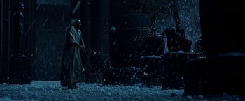 Movie still from “Exodus: Gods and Kings” (2014), directed by Ridley Scott – A man in a white robe standing next to a tree; Wide shot, High angle