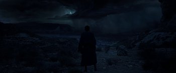 Movie still from “Exodus: Gods and Kings” (2014), directed by Ridley Scott – A man standing in the dark looking at the sky at night; Extreme Wide shot, High angle