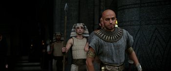 Movie still from “Exodus: Gods and Kings” (2014), directed by Ridley Scott – A group of men dressed in ancient egyptian costumes; Medium shot, Over the shoulder angle