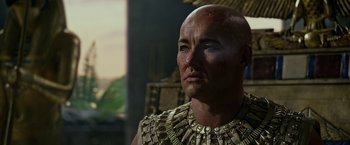 Movie still from “Exodus: Gods and Kings” (2014), directed by Ridley Scott – A man with a bald head wearing a necklace; Close Up shot, Low angle
