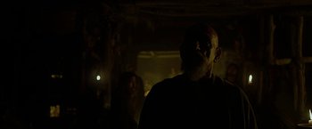 Movie still from “Exodus: Gods and Kings” (2014), directed by Ridley Scott – An old man is standing in a dark room; Medium shot, Low angle