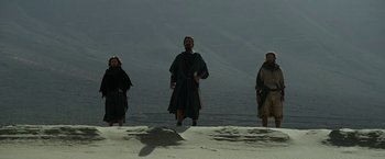 Movie still from “Exodus: Gods and Kings” (2014), directed by Ridley Scott – A group of people standing on top of a sandy beach; Wide shot, Low angle