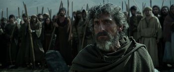 Movie still from “Exodus: Gods and Kings” (2014), directed by Ridley Scott – A group of men standing next to each other in a field; Medium shot, Low angle