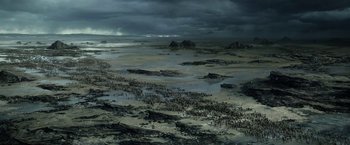 Movie still from “Exodus: Gods and Kings” (2014), directed by Ridley Scott – An aerial view of people gathered on the beach; Extreme Wide shot, High angle