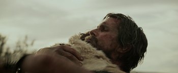Movie still from “Exodus: Gods and Kings” (2014), directed by Ridley Scott – A man with long hair and a beard is holding a fur coat over his face; Close Up shot, Low angle