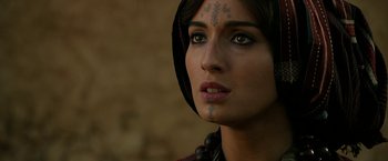 Movie still from “Exodus: Gods and Kings” (2014), directed by Ridley Scott – A person with a tattoo on their face; Close Up shot, Over the shoulder angle