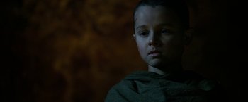 Movie still from “Exodus: Gods and Kings” (2014), directed by Ridley Scott – A young boy is wearing a green shirt; Close Up shot, Low angle