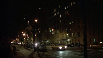 Movie still from “Eyes Wide Shut” (1999), directed by Stanley Kubrick – A city street at night lit by street lights; Extreme Wide shot, High angle