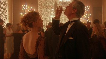 Movie still from “Eyes Wide Shut” (1999), directed by Stanley Kubrick – A man and a woman in formal wear drinking wine; Medium shot, Low angle