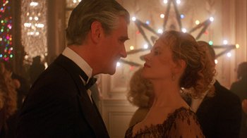 Movie still from “Eyes Wide Shut” (1999), directed by Stanley Kubrick – A man and a woman standing next to each other in front of lights; Close Up shot, Low angle