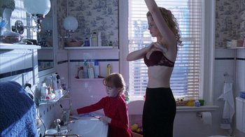 Movie still from “Eyes Wide Shut” (1999), directed by Stanley Kubrick – A woman and a child in a room; Medium shot, Over the shoulder angle