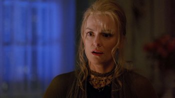 Movie still from “Eyes Wide Shut” (1999), directed by Stanley Kubrick – A person with long blonde hair; Close Up shot, Over the shoulder angle