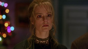 Movie still from “Eyes Wide Shut” (1999), directed by Stanley Kubrick – A person wearing a necklace and looking sad; Close Up shot, Low angle