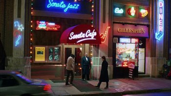 Movie still from “Eyes Wide Shut” (1999), directed by Stanley Kubrick – Three people are standing outside of a cafe; Extreme Wide shot, High angle