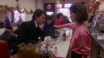 Movie still from “Eyes Wide Shut” (1999), directed by Stanley Kubrick – A man and a woman sitting at a table; Medium shot, Over the shoulder angle
