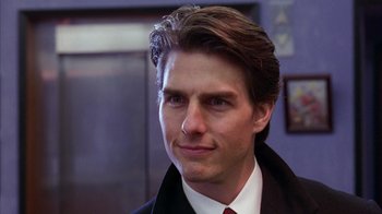 Movie still from “Eyes Wide Shut” (1999), directed by Stanley Kubrick – A person wearing a suit and tie; Close Up shot, Over the shoulder angle