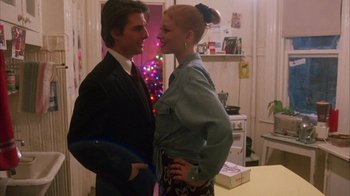 Movie still from “Eyes Wide Shut” (1999), directed by Stanley Kubrick – A man and a woman standing next to each other in front of a christmas tree; Medium shot, Over the shoulder angle