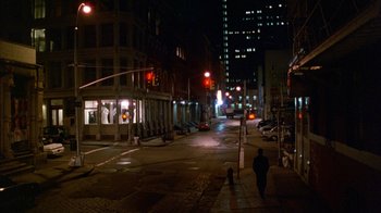 Movie still from “Eyes Wide Shut” (1999), directed by Stanley Kubrick – A man walking down a street at night; Extreme Wide shot, High angle