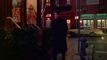 Movie still from “Eyes Wide Shut” (1999), directed by Stanley Kubrick – A man standing on the sidewalk at night; Wide shot, Low angle
