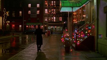 Movie still from “Eyes Wide Shut” (1999), directed by Stanley Kubrick – A person walking down a street at night; Extreme Wide shot, Low angle
