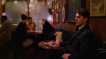 Movie still from “Eyes Wide Shut” (1999), directed by Stanley Kubrick – A group of people sitting at a table in a restaurant; Medium shot, Over the shoulder angle