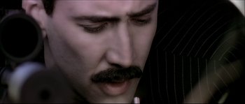 Movie still from “Face/Off” (1997), directed by John Woo – A person with a mustache; Close Up shot, Low angle