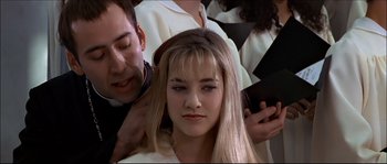 Movie still from “Face/Off” (1997), directed by John Woo – A woman getting her hair done by a man; Close Up shot, Over the shoulder angle