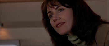 Movie still from “Face/Off” (1997), directed by John Woo – A person with long hair; Close Up shot, Over the shoulder angle