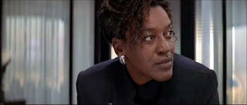 Movie still from “Face/Off” (1997), directed by John Woo – A person wearing a suit; Close Up shot, Low angle