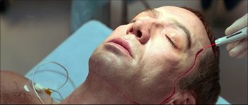 Movie still from “Face/Off” (1997), directed by John Woo – A person laying on a bed; Close Up shot, Overhead angle