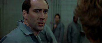 Movie still from “Face/Off” (1997), directed by John Woo – Nicolas cage in front of two other men; Close Up shot, Low angle