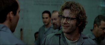 Movie still from “Face/Off” (1997), directed by John Woo – A group of men standing next to each other in a room; Close Up shot, Over the shoulder angle