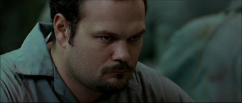 Movie still from “Face/Off” (1997), directed by John Woo – A person with a beard; Close Up shot, High angle