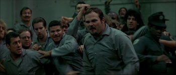 Movie still from “Face/Off” (1997), directed by John Woo – A group of men standing next to each other in a room; Medium shot, High angle