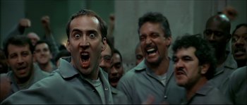 Movie still from “Face/Off” (1997), directed by John Woo – A group of men standing next to each other; Close Up shot, Low angle