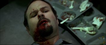 Movie still from “Face/Off” (1997), directed by John Woo – A man with blood all over his face; Close Up shot, High angle