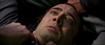 Movie still from “Face/Off” (1997), directed by John Woo – A man's face as he lies in bed; Extreme Close Up shot, Overhead angle