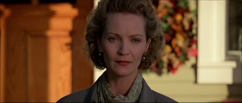 Movie still from “Face/Off” (1997), directed by John Woo – A person with curly hair wearing a jacket; Close Up shot, Low angle