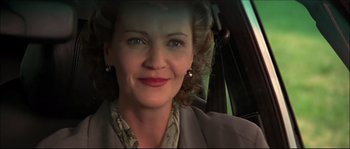 Movie still from “Face/Off” (1997), directed by John Woo – A person in a car; Close Up shot, Low angle