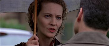 Movie still from “Face/Off” (1997), directed by John Woo – A person holding an open umbrella; Close Up shot, Low angle