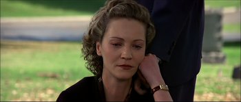 Movie still from “Face/Off” (1997), directed by John Woo – A person with a hand on the ear of another person; Close Up shot, Over the shoulder angle